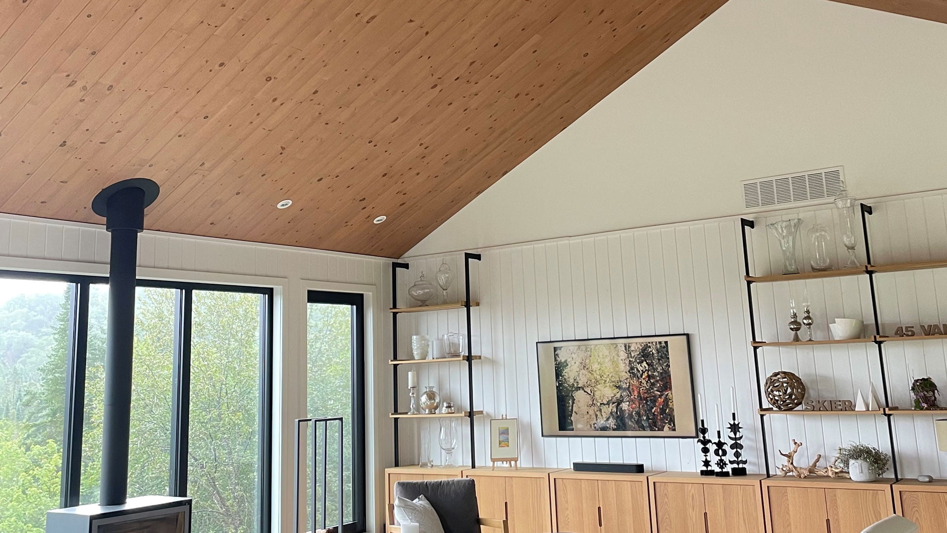 Natural white pine paneled ceiling and white paneled walls.