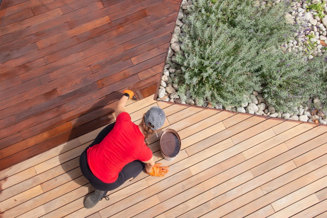 A woman does deck maintenance